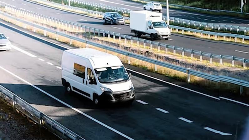 Two delivery vans on a highway