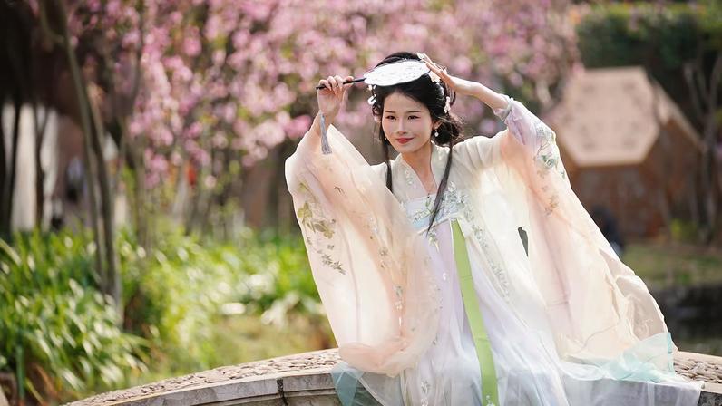 A woman dressed in traditional Hanfu costume poses for a photo at Daguan Park in Kunming, Yunnan Province in southwest China.