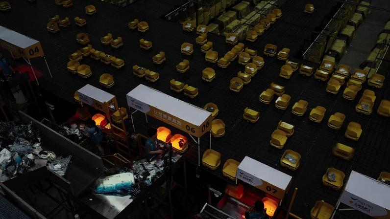Autonomous robots sort express parcels at a logistics centre at Chinese apparel brand Fast Fish during the 618 Shopping Festival on June 18, 2026 in Deqing, China.
