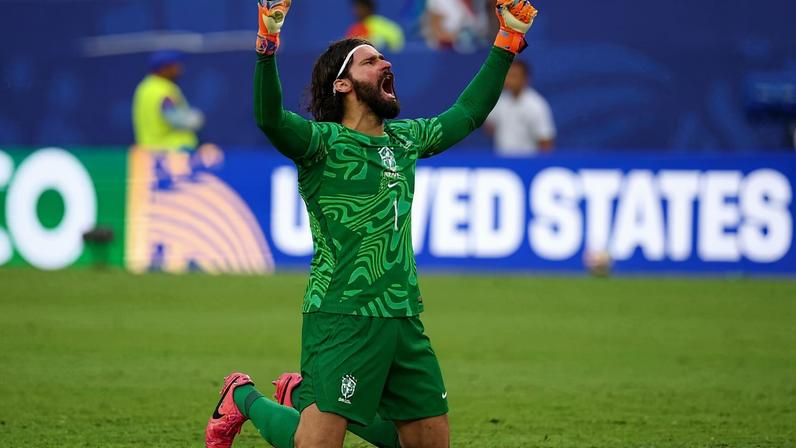 MIAMI GARDENS, FLORIDA - JUNE 24: Alisson #1 of Brazil celebrates after the team's second goal by Vinicius Junior #7 during the FIFA World Cup 2026 Group C match between Scotland and Brazil at Miami Stadium on June 24, 2026 in Miami Gardens, Florida. Robert Cianflone/Getty Images/AFP