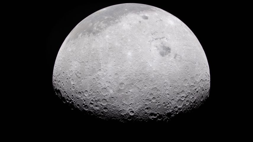 The Moon's rugged surface is on display in this image. Most of the Moon is visible, with the bottom of the sphere disappearing into the darkness. This line between light and dark is called the terminator. The terminator is lined with many craters.
