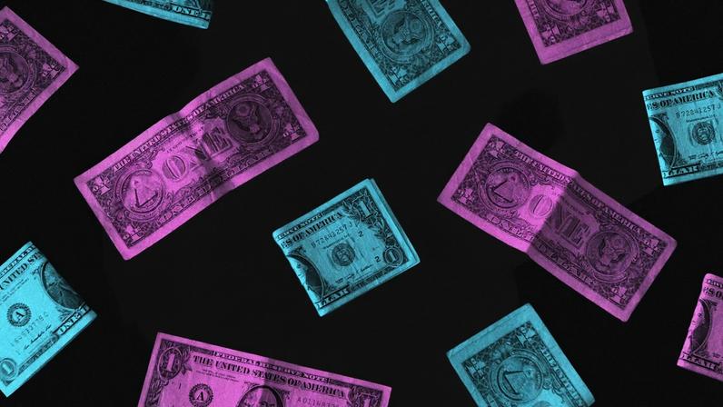 A pregnant woman with pink and blue dollar bills.
