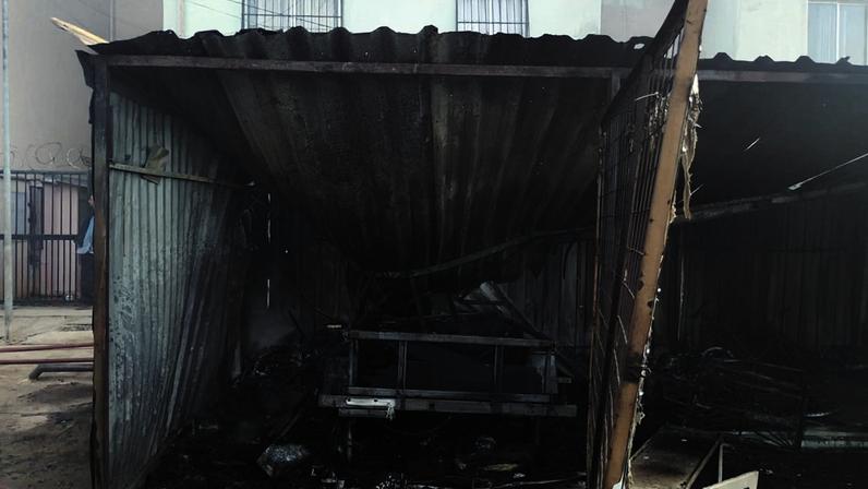 Carro e carretinha foram queimados em após incêndio em vegetação atingir estacionamento de condomínio em Contagem
