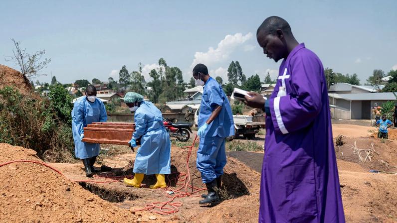 A priest conducts a blessing ceremony at Mbiyo Cemetery for an orphan who died from Ebola in Bunia on June 19, 2026.