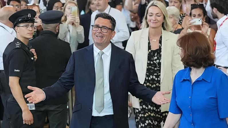 PA Media Andy Burnham opens his arms wide with MPs looking on behind him