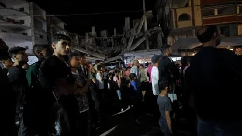 Palestinos assistem à partida do Grupo G da Copa do Mundo Fifa de 2026 entre Bélgica e Egito em um telão instalado no campo de refugiados de Nuseirat, no centro de Gaza, Palestina, em 15 de junho de 2026. A exibição reuniu moradores do campo para acompanhar o torneio sediado pelos EUA