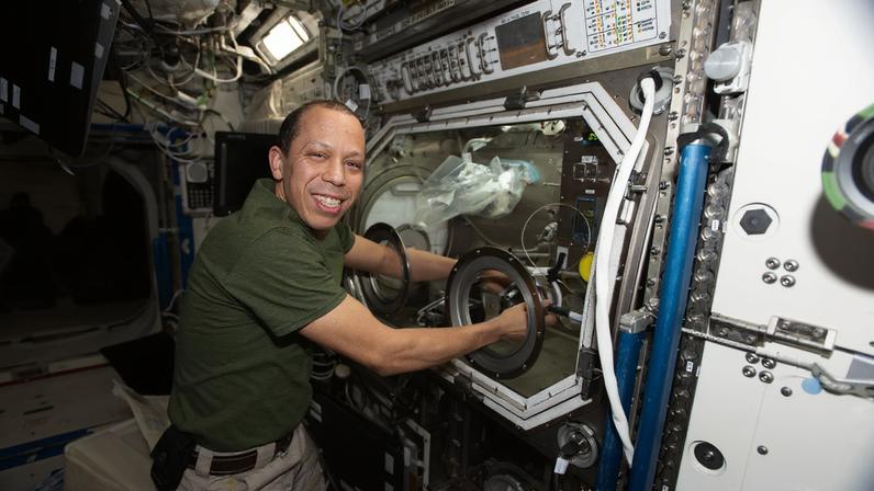 NASA astronaut and Expedition 74 Flight Engineer Chris Williams replaces sample hardware inside the Destiny laboratory module’s Microgravity Science Glovebox aboard the International Space Station to support semiconductor crystal research. Growing crystals in weightlessness may enable future large-scale semiconductor manufacturing, advancing the commercial space economy and supporting Earth-based industries.