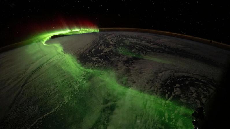 The aurora australis arcs over Earth during an active solar event in this photograph taken at approximately 11:32 p.m. local time from the International Space Station as it orbited 271 miles above the Indian Ocean southwest of Perth, Australia.