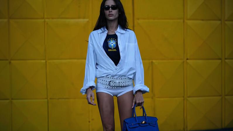Influenciadora Livia Nunes combinando a camiseta oficial da seleção brasileira com shorts e camisa