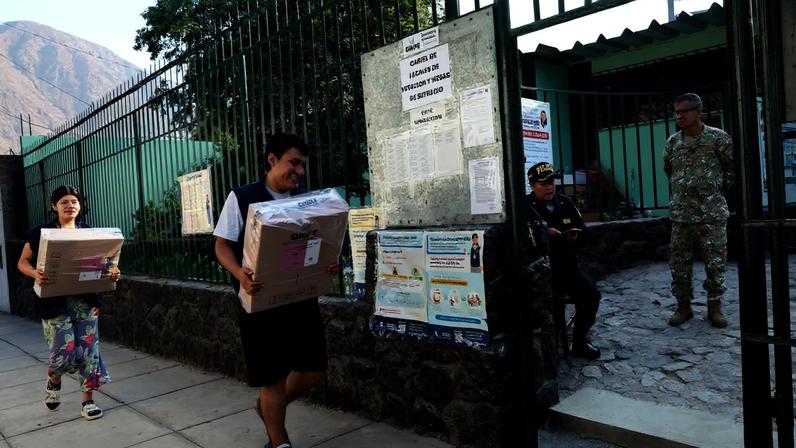 Peruvian electoral workers distribute voting materials to polling stations, as police and military personnel stand guard, ahead of the April 12 general election, in Lima, Peru, April 11, 2026. REUTERS/Manuel Orbegozo