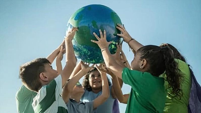 Children holding a planet outdoors