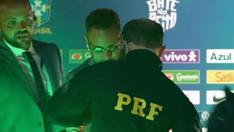 Agente da PRF pede autógrafo de Neymar durante embarque da Seleção para a Copa