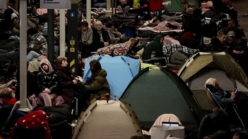 Pessoas se abrigam dentro de uma estação de metrô durante um ataque aéreo russo em Kiev