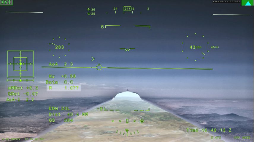NASA’s X-59 eXternal Vision System digital display shows green flight data overlaid on the forward scenery as the aircraft flies supersonic. Numerical indicators, horizon references, and a Mach number readout are visible on the screen.