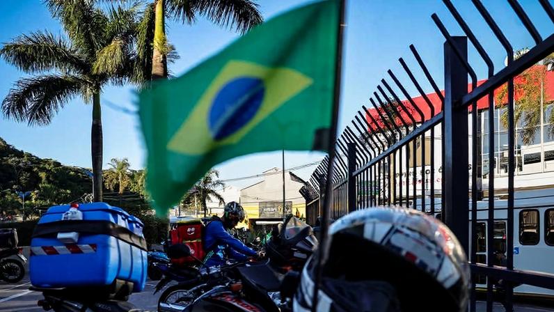 Movimentação de trabalhadores de aplicativos de entrega em estacionamento destinado a motoboys para retirada de pedidos, na região de Mauá (SP)