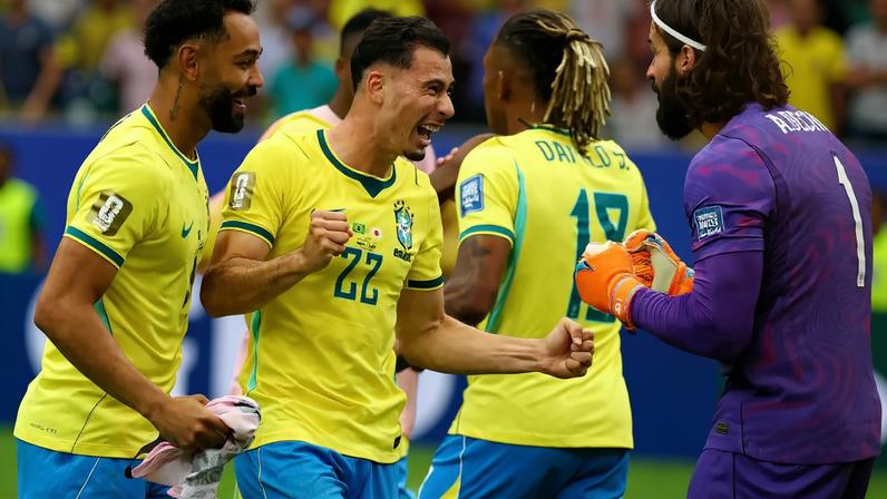 Brazil's Matheus Cunha, Gabriel Martinelli and Alisson Becker celebrate after the match