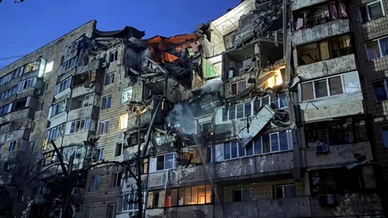 An apartment building hit during Russian missile and drone strikes on Kyiv on Monday.