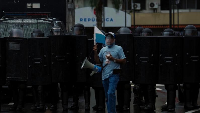 A demonstrator stands by police blocking access to Panama’s National Assembly as people protested against a new mining contract between Canada’s First Quantum Minerals and the Panamanian government for the Cobre Panama copper mine on Oct. 20, 2023. Photo by Arnulfo Franco via Associated Press.