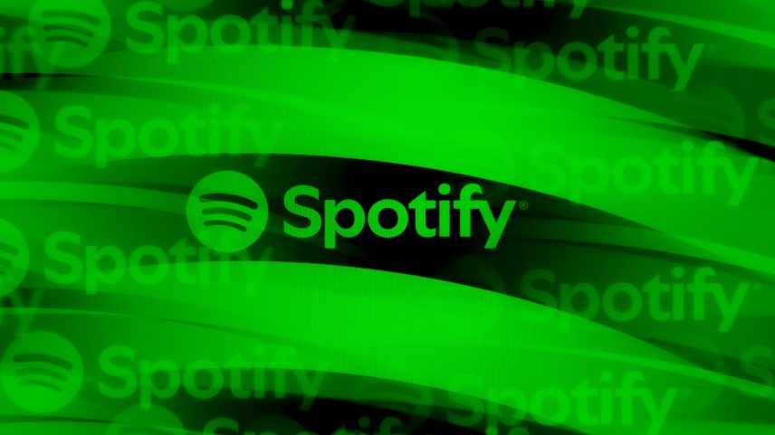 The Spotify logo is displayed on a computer screen photographed using a kaleidoscopic filter.