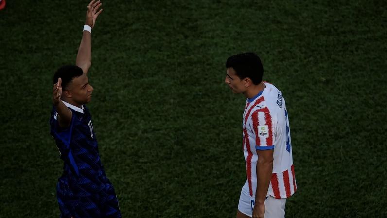 Mbappe celebrates in the face of an opponent