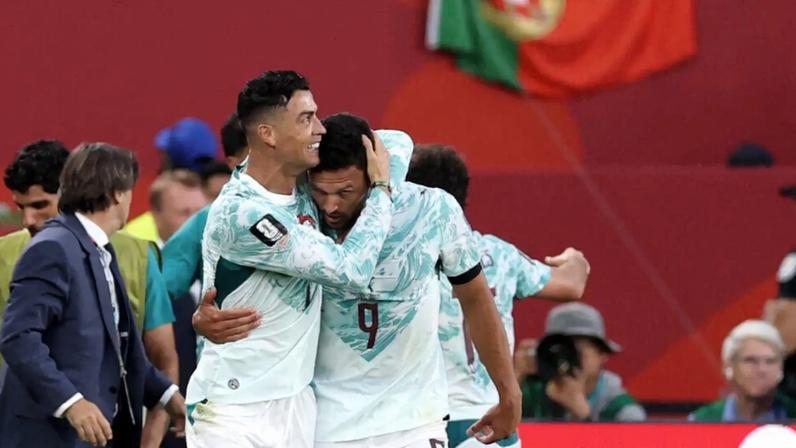 A substituted Cristiano Ronaldo celebrates with Goncalo Ramos