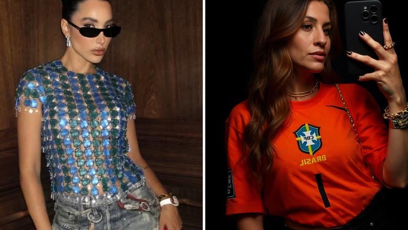 Duas mulheres posam para fotos. À esquerda, uma mulher de coque, óculos escuros e blusa azul e verde de lantejoulas. À direita, uma mulher de cabelos longos e ruivos, camiseta laranja da seleção brasileira e calça preta, tirando uma selfie no espelho