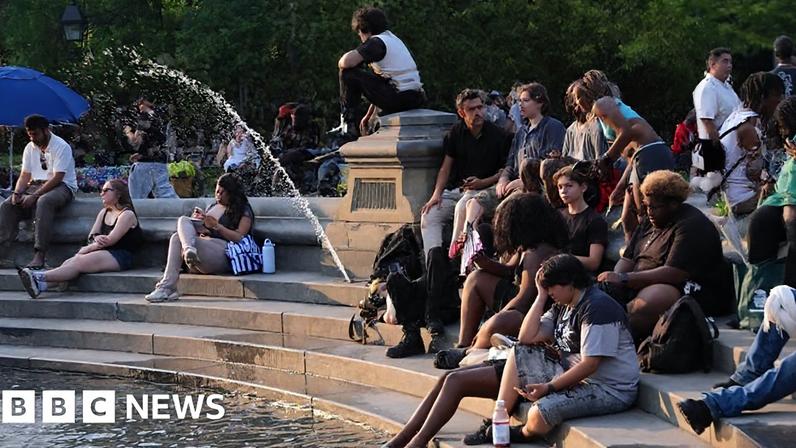 People cooling down near a fountain during extreme heat in New York City