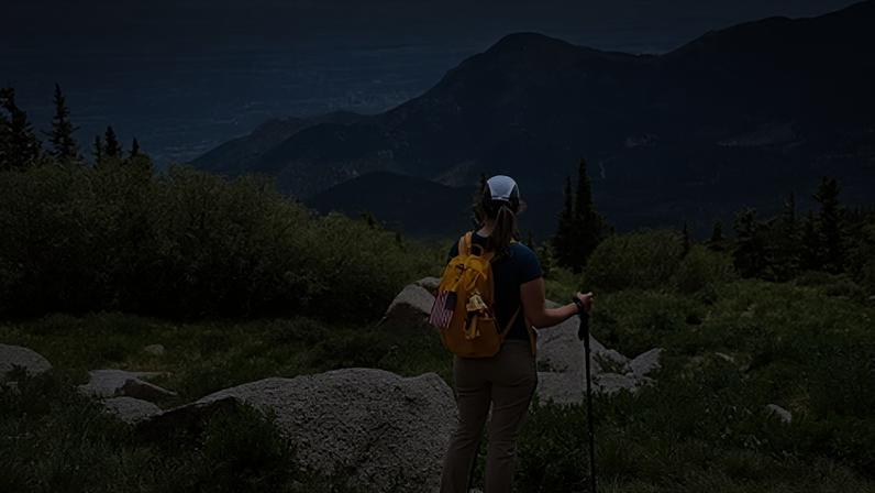 Rob Shearer A woman surveys the vast view from a mountaintop (Credit: Rob Shearer)