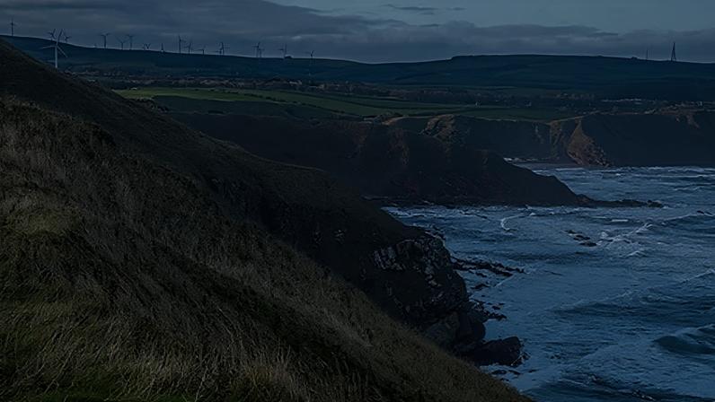 Getty Images Grassy cliffs overlooking the North Sea with rugged headlands and waves breaking below (Credit: Getty Images)
