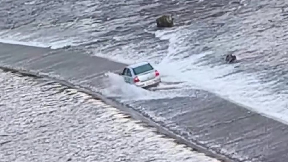 Carro é flagrado atravessando barragem submersa em vídeo impressionante Carro ultrapassa barragem coberta por água no RS (Foto: Arquivo pessoal/ Daniel Scherer)