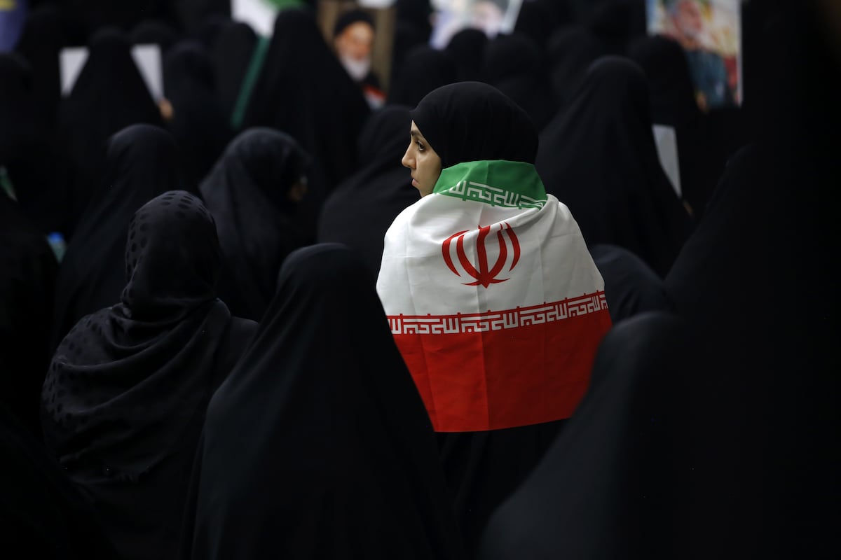 Uma mulher envolta na bandeira do Irã, fotografada durante o memorial de 2 de julho em memória dos mortos pelos ataques israelenses. (Foto: Fatemeh Bahrami / Anadolu / Getty Images)