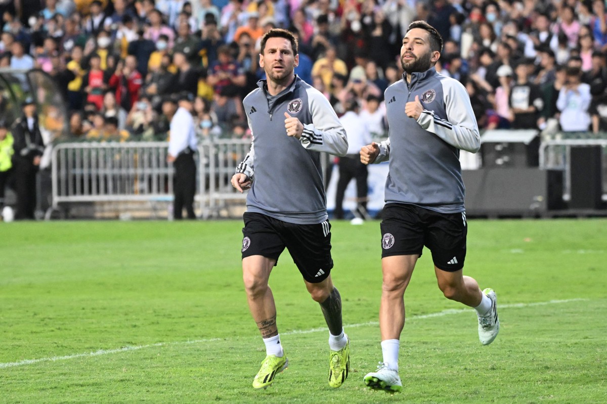 Lionel Messi durante treino em Hong Kong, ao lado de Jordi Alba (Foto: PETER PARKS / AFP)