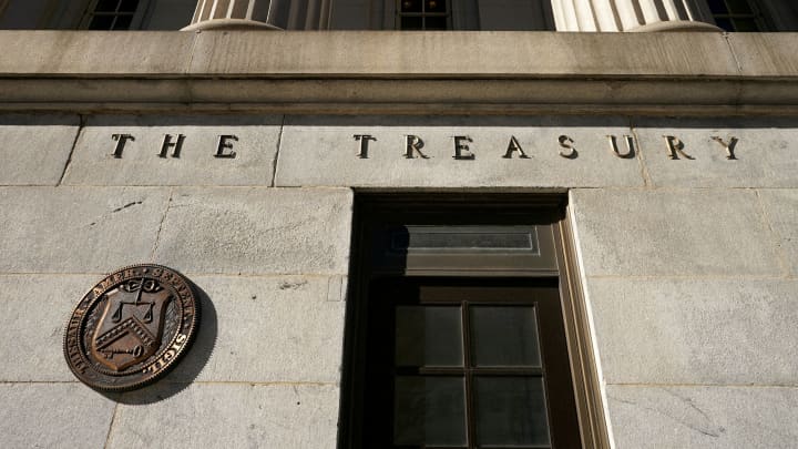 Tesouro dos EUA registra superávit inesperado em junho com alta nas tarifas Uma vista mostra um selo de bronze ao lado de uma porta no edifício do Tesouro dos EUA em Washington, EUA, 20 de janeiro de 2023. (Foto: Kevin Lamarque | Reuters)