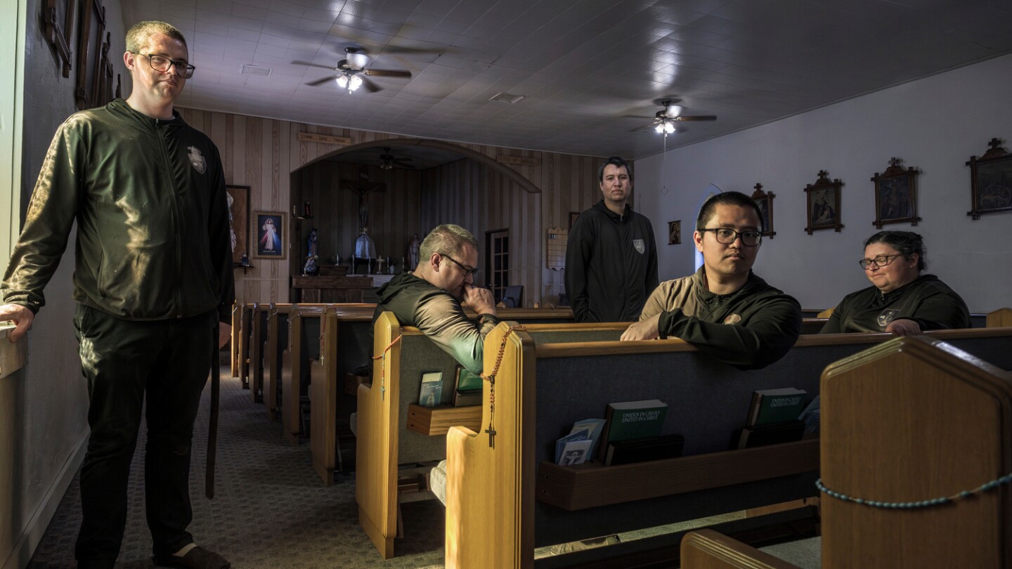 Membros da Liga do Santíssimo Sacramento, Edward Seeley, da esquerda para a direita, Eric Faris, Giovanni Vizcarra, Anthony Ribaya e Lisa Hezmalhalch, se reúnem dentro da igreja paroquial de San Rafael em Concho, Arizona, no sábado, 21 de junho de 2025. O Bispo James S. Wall ordenou ao grupo leigo de jovens católicos que deixasse a habitação paroquial e parasse de liderar a liturgia e ensinar na escola católica da região. (Foto: AP Photo/Roberto E. Rosales)