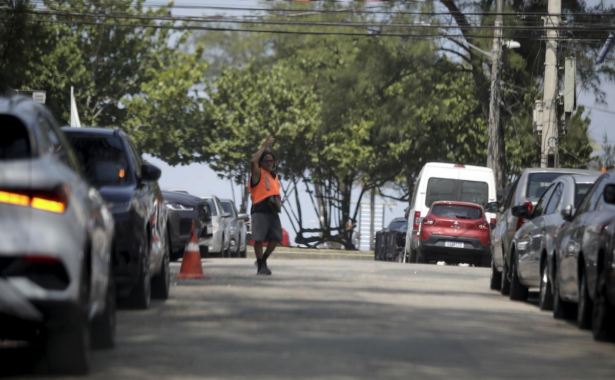 Projeto propõe cobrança digital para vagas de estacionamento e afasta flanelinhas Flanelinha estaciona carros numa rua do Recreio, perto da praia (Foto: Fabiano Rocha / Agência O Globo)