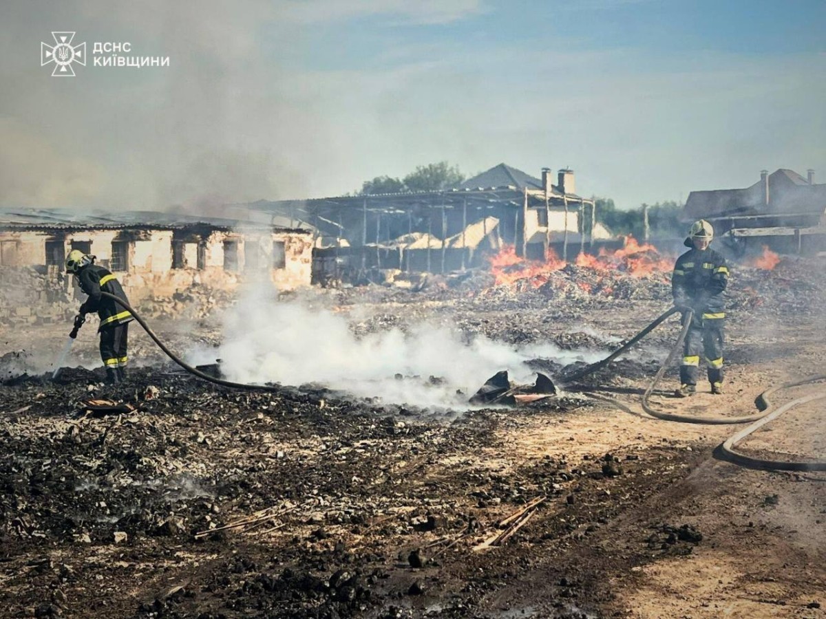 Bombeiros apagam incêndio após um ataque russo na região de Kiev, em meio à invasão russa da Ucrânia. (Foto: AFP)
