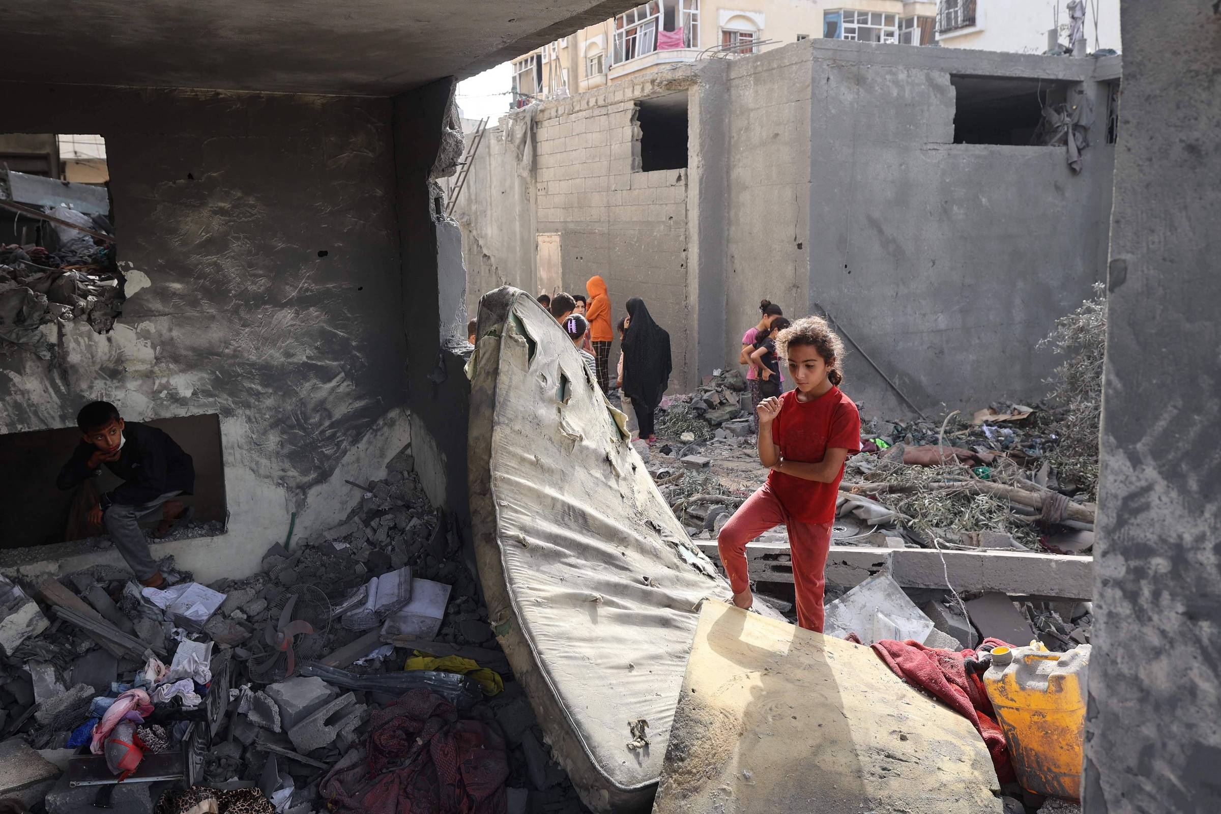 Negócios lucrativos sustentam 'campanha genocida' em Gaza, afirma especialista da ONU Crianças sobre os escombros de uma construção residencial em Deir al-Balah, na Faixa de Gaza (Foto: Eyad Baba/1.jul.25/AFP)