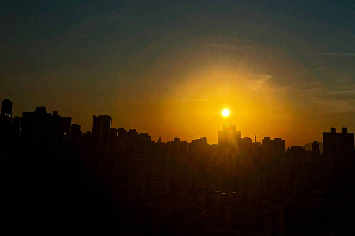São Paulo registra a tarde mais quente em 25 dias após manhã fria Pôr do sol ristrado entre prédios no centro de São Paulo; cidade deve ter dia de céu aberto nesta terça-feira (22) (Foto: Rafaela Araújo)
